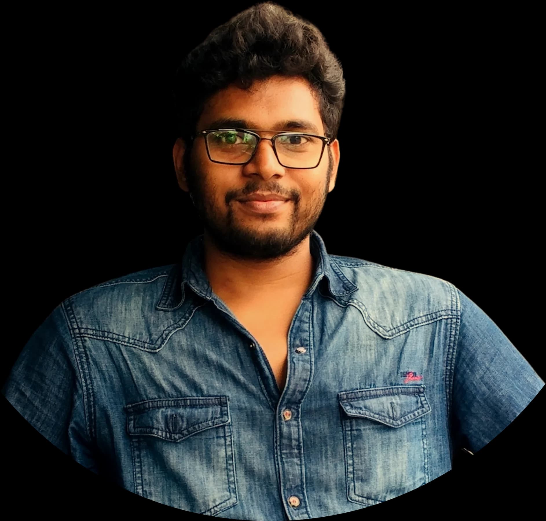 Aditya Raman, smiling, in a denim shirt